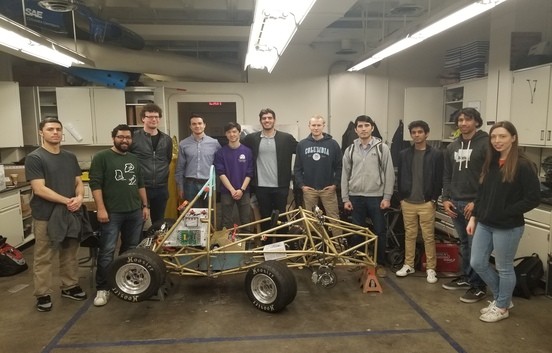 Group of students standing in front of prototype EV